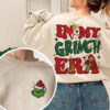 Playful In My Grinch Era shirt with playful Christmas design, featuring back and pocket prints.