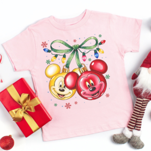 Coquette Bow Disney Christmas Shirt folded with Christmas decor in background