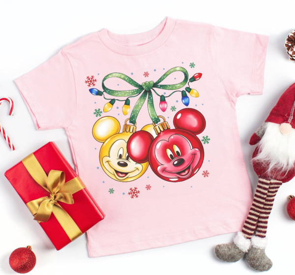 Coquette Bow Disney Christmas Shirt folded with Christmas decor in background