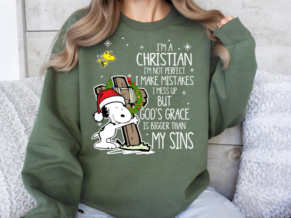 Snoopy hugging a cross with a wreath and Santa hat, accompanied by the text 'I’m a Christian, I’m not perfect, I make mistakes, I mess up, but God’s grace is bigger than my sins