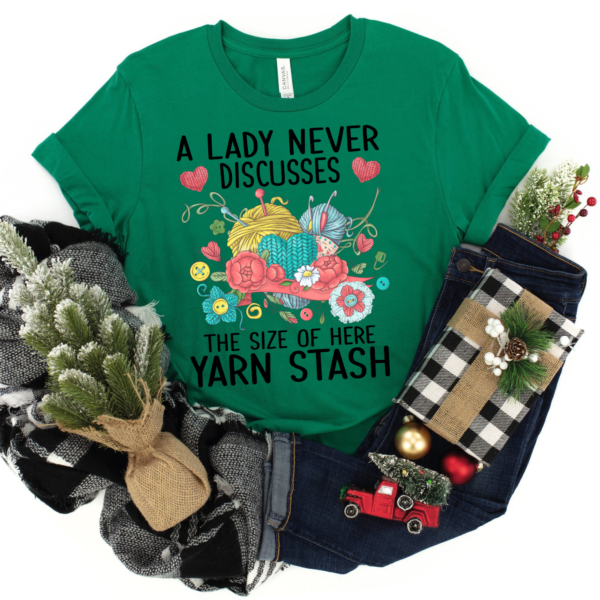 Knitting and crochet shirt featuring vibrant flowers, buttons, and yarn graphic