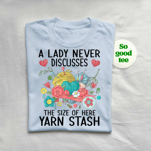 Knitting and crochet shirt featuring vibrant flowers, buttons, and yarn graphic